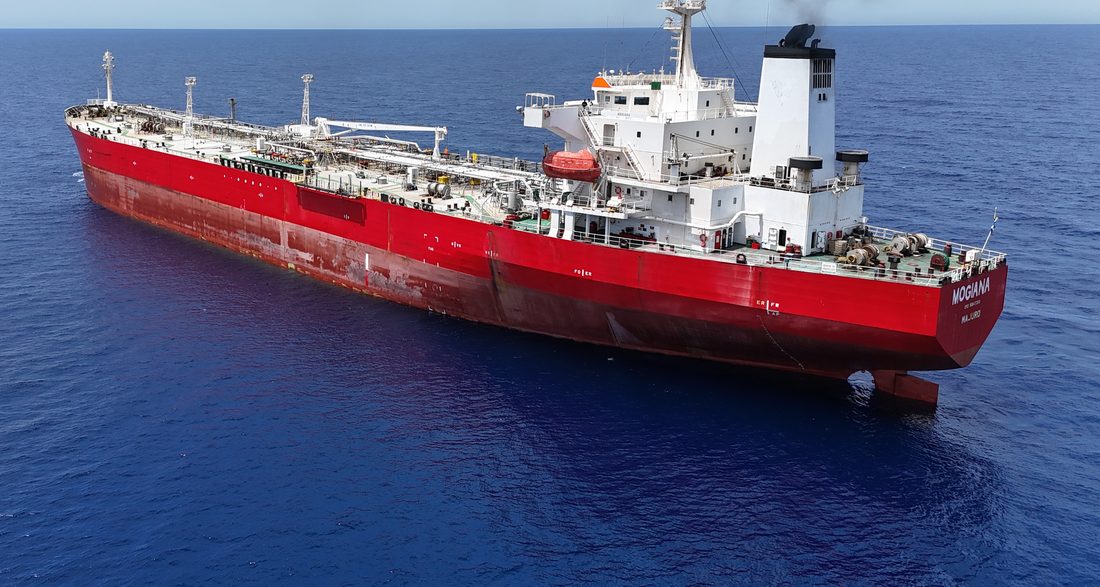 Red-hulled oil and chemical tanker at sea, seen from astern